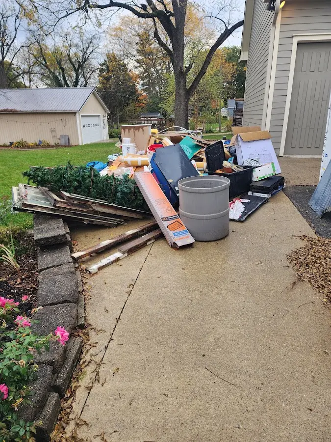 Dumpster being loaded with debris for Commercial Dumpster Rental in Sweet Home